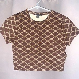 A crop top with ‘baddie’ in small print. Small, but fits big chests too.